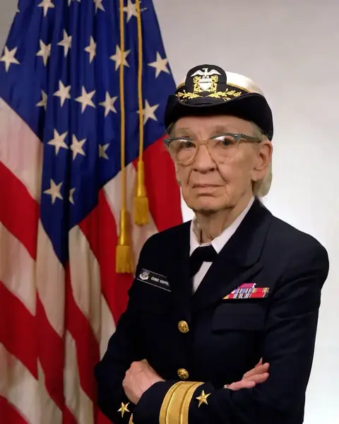 Grace Hopper 海军准将。她做的 A-0 系统让机器自己去查表、翻译程序，compiler（编译器）这个词由她推广开。
